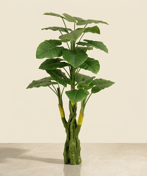 A tall artificial potted plant with large green tropical leaves and a twisted green trunk, displayed against a plain beige background.
