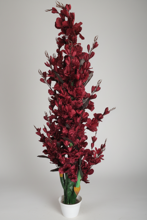 A tall artificial floral arrangement in a white pot, shown prominently at the top and repeated in multiple smaller interior room scenes along the bottom. The product appears to be a decorative faux plant with dense dark red to burgundy leaves and stems, plus green leafy lower portions.