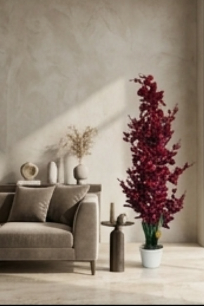 A tall artificial floral arrangement in a white pot, shown prominently at the top and repeated in multiple smaller interior room scenes along the bottom. The product appears to be a decorative faux plant with dense dark red to burgundy leaves and stems, plus green leafy lower portions.